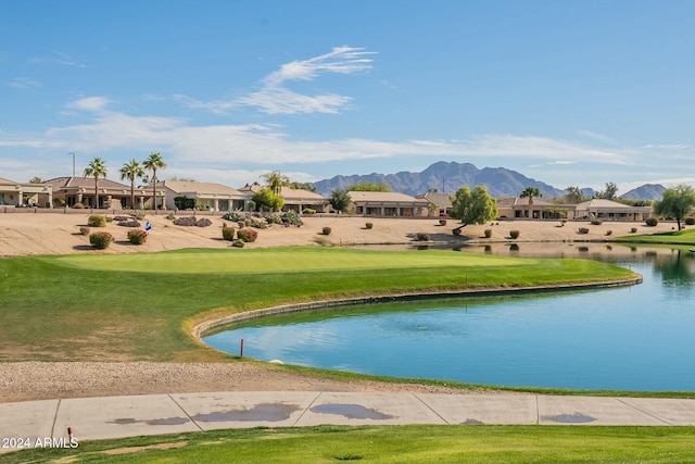 view of property's community with a yard and a water and mountain view