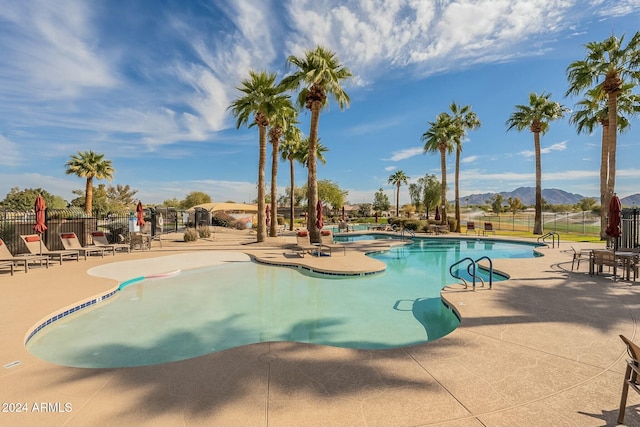 view of pool featuring a patio area and a mountain view