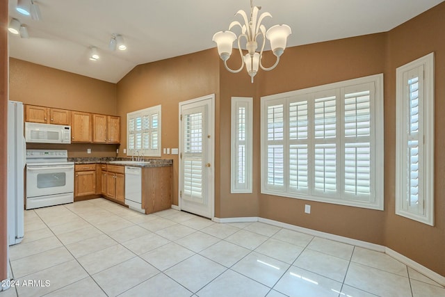 kitchen featuring white appliances, lofted ceiling, hanging light fixtures, a notable chandelier, and light tile patterned flooring