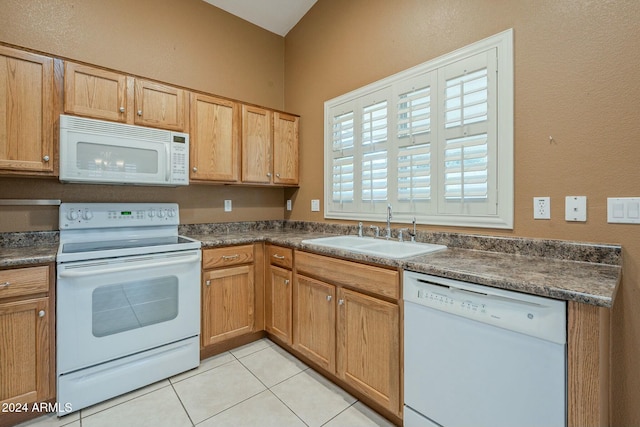 kitchen with sink, light tile patterned flooring, and white appliances