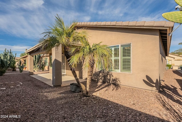 back of property featuring a patio