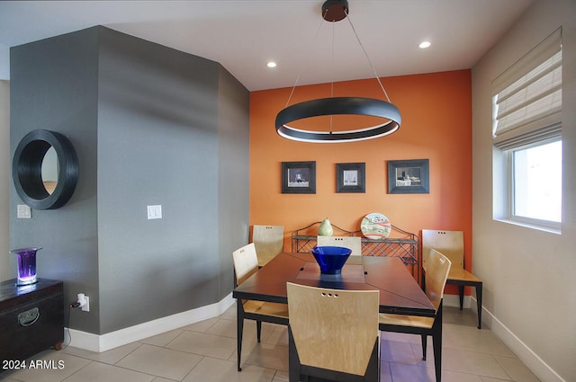 tiled dining room with recessed lighting and baseboards