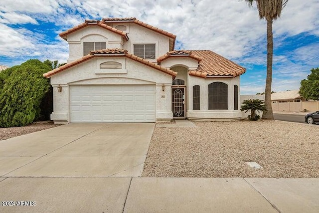 mediterranean / spanish house with a garage