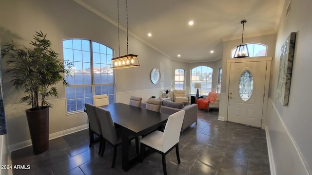 tiled dining area with crown molding and a high ceiling