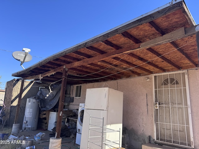 view of patio with washer / dryer and water heater