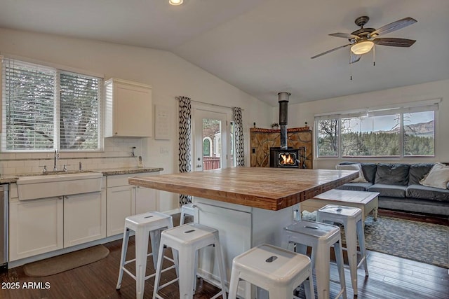 2974 N Vista Way, Payson, AZ 85541 - kitchen with open floor plan, a sink, a wood stove, butcher block countertops, and dark wood finished floors