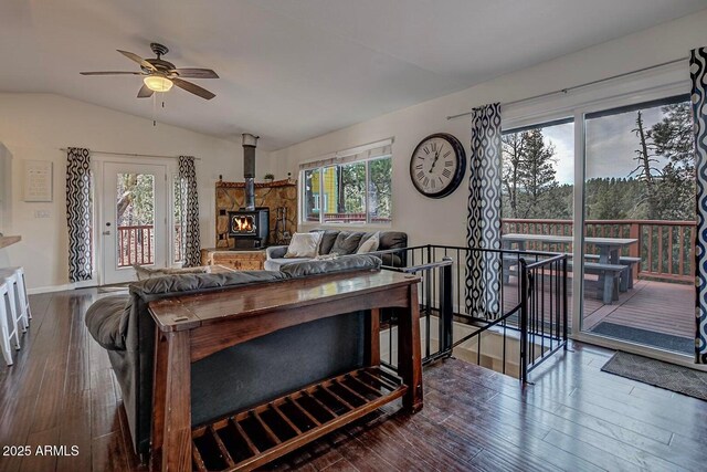 2974 N Vista Way, Payson, AZ 85541 - living area with vaulted ceiling, dark wood-style flooring, a wood stove, a ceiling fan, and baseboards