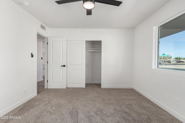 unfurnished bedroom with carpet floors, a closet, and ceiling fan