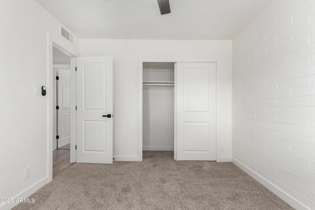 unfurnished bedroom with a closet, ceiling fan, and light colored carpet