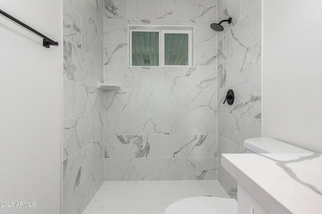 bathroom featuring vanity, toilet, and tiled shower