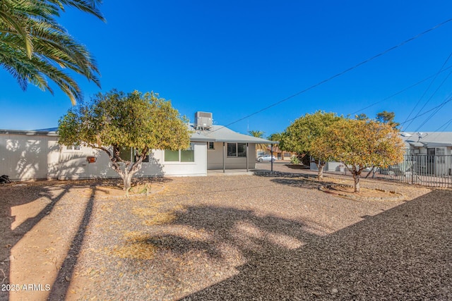 rear view of property with a patio area and cooling unit