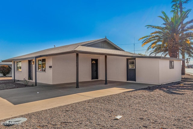 ranch-style home featuring a carport