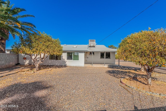 back of property featuring cooling unit and a patio