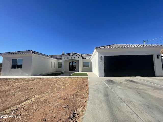 mediterranean / spanish house with a garage