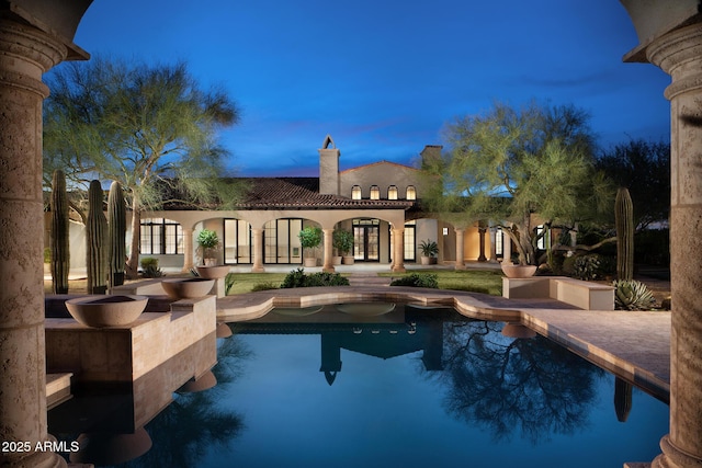 outdoor pool featuring french doors and a patio