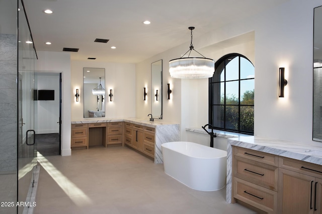 full bath with a freestanding tub, a stall shower, recessed lighting, a chandelier, and vanity