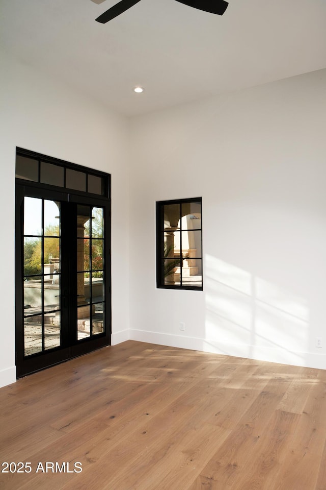 empty room featuring recessed lighting, baseboards, ceiling fan, and wood finished floors