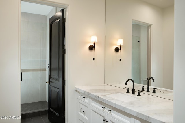 bathroom featuring a tile shower and vanity