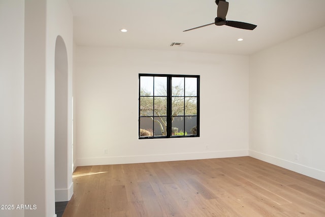 unfurnished room with visible vents, recessed lighting, light wood-type flooring, and baseboards