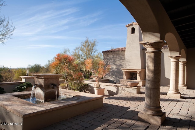 view of patio / terrace featuring an outdoor fireplace