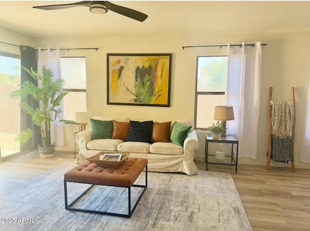 living room with a ceiling fan and wood finished floors
