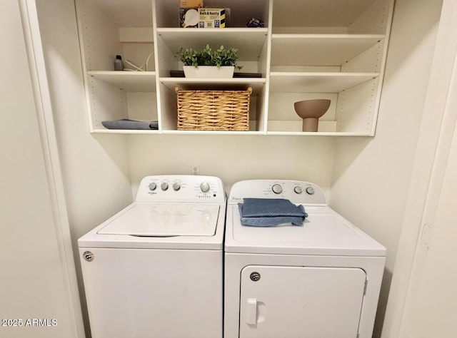 laundry room featuring separate washer and dryer and laundry area