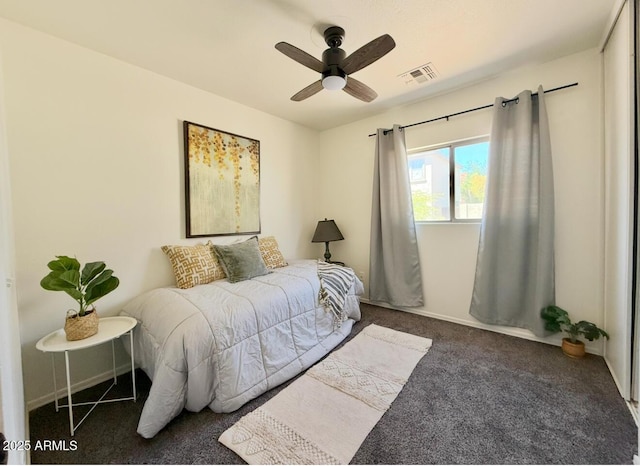 carpeted bedroom featuring ceiling fan and visible vents