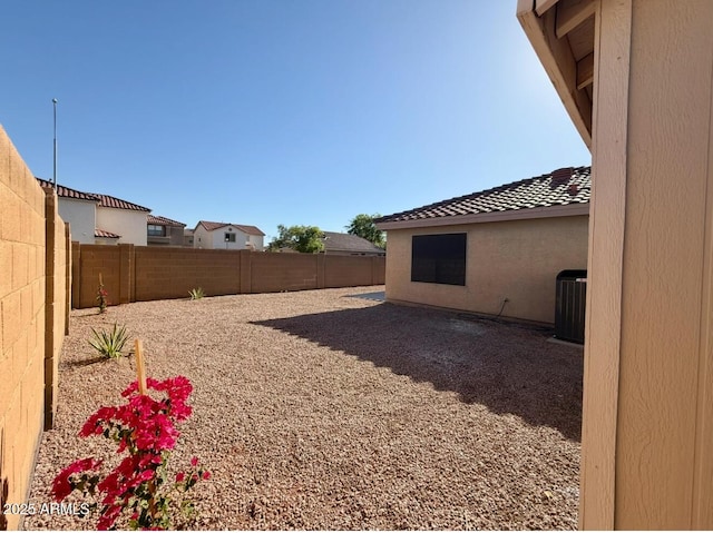 view of yard featuring central air condition unit and a fenced backyard
