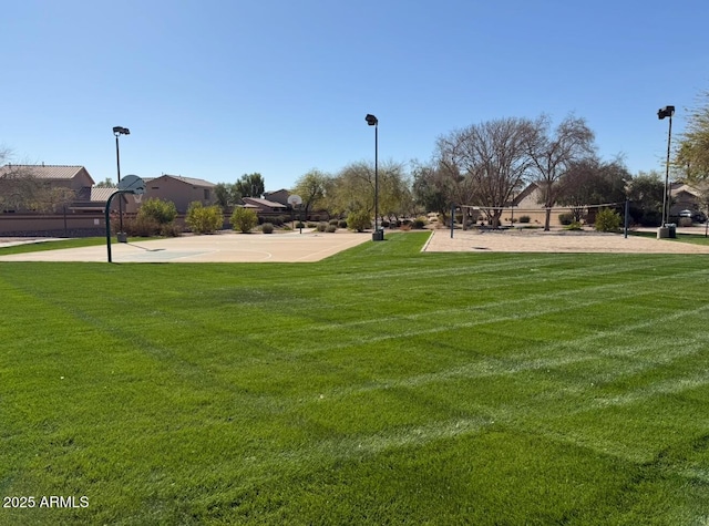 view of community featuring a lawn and volleyball court