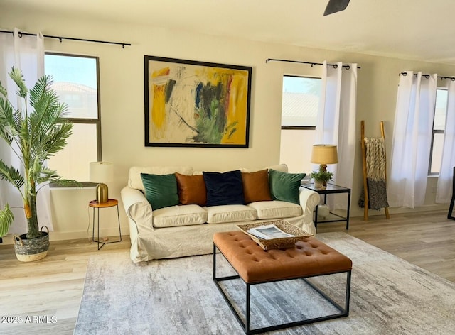 living room featuring a ceiling fan and wood finished floors