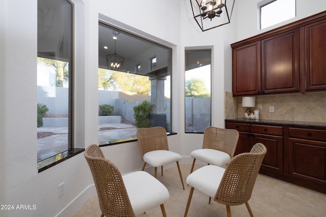 tiled dining space featuring an inviting chandelier