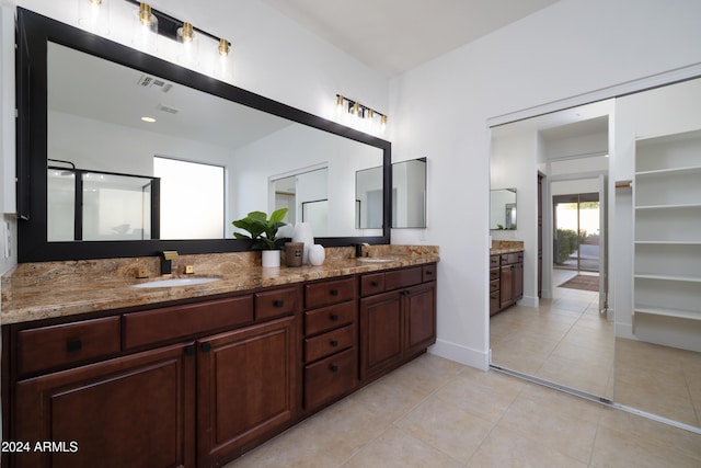 bathroom featuring vanity, tile patterned floors, and a shower with door