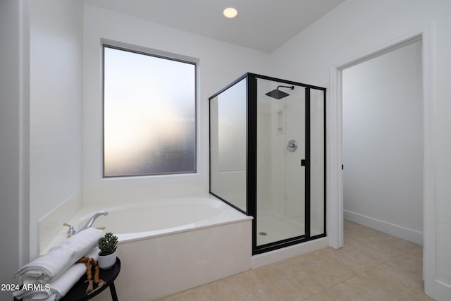 bathroom with tile patterned floors and plus walk in shower