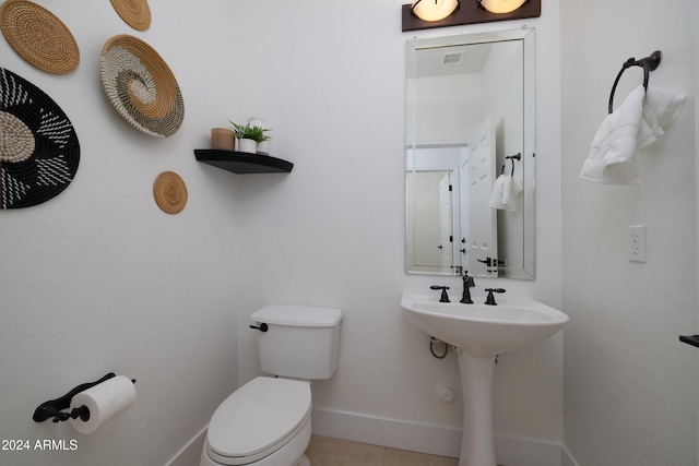 bathroom with tile patterned floors and toilet