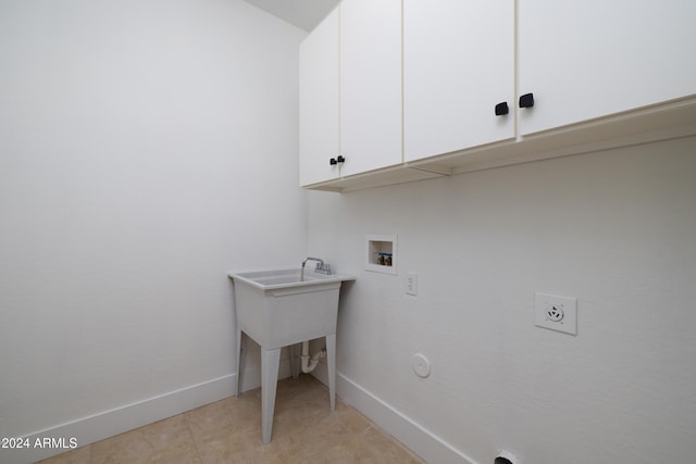 clothes washing area with cabinets, hookup for an electric dryer, gas dryer hookup, and washer hookup