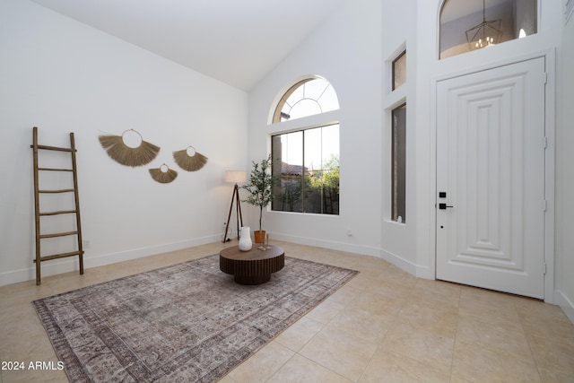 tiled foyer entrance with high vaulted ceiling