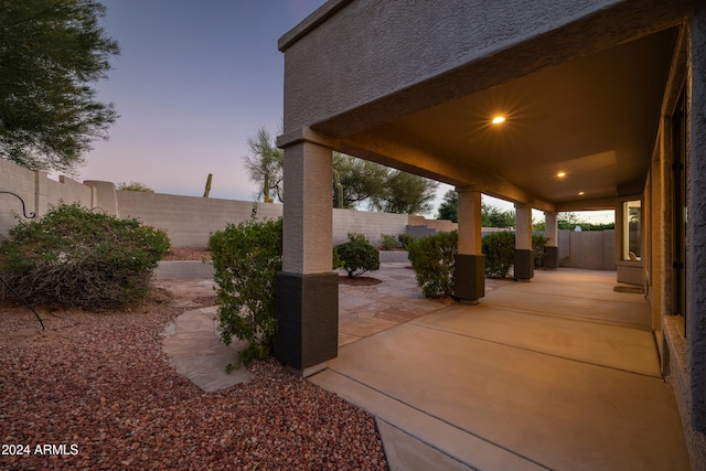 view of patio terrace at dusk