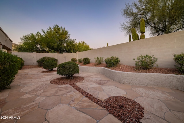 view of patio terrace at dusk