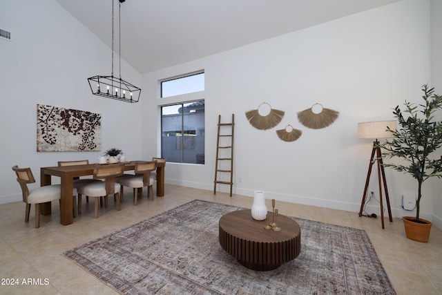 tiled dining room featuring high vaulted ceiling