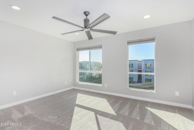 spare room featuring ceiling fan and carpet floors