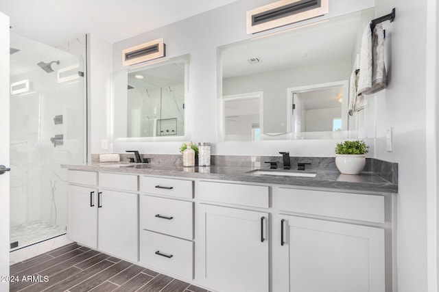 bathroom featuring walk in shower and vanity