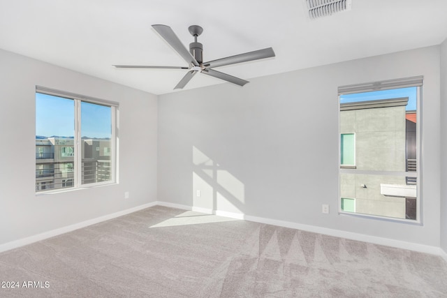 unfurnished room featuring carpet floors and ceiling fan