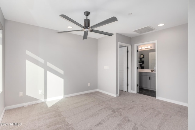 unfurnished bedroom featuring carpet flooring, ceiling fan, and connected bathroom