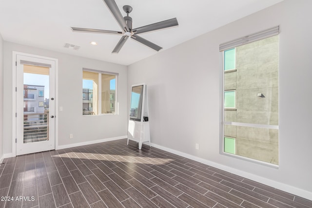 spare room featuring ceiling fan and dark hardwood / wood-style flooring