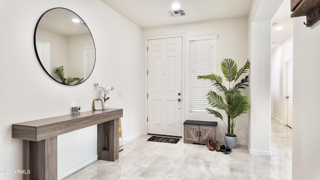 foyer with recessed lighting, visible vents, and baseboards