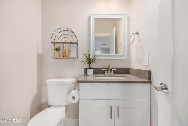 bathroom featuring toilet and vanity