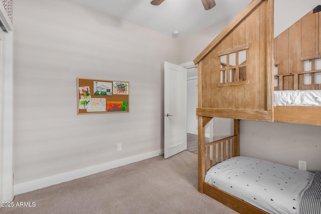 bedroom with light carpet, ceiling fan, and baseboards