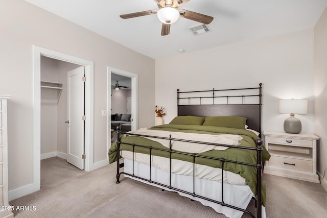 carpeted bedroom featuring baseboards, a spacious closet, visible vents, and a closet