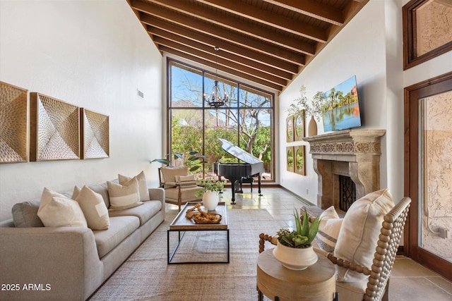 living room featuring beamed ceiling, baseboards, high vaulted ceiling, and a fireplace