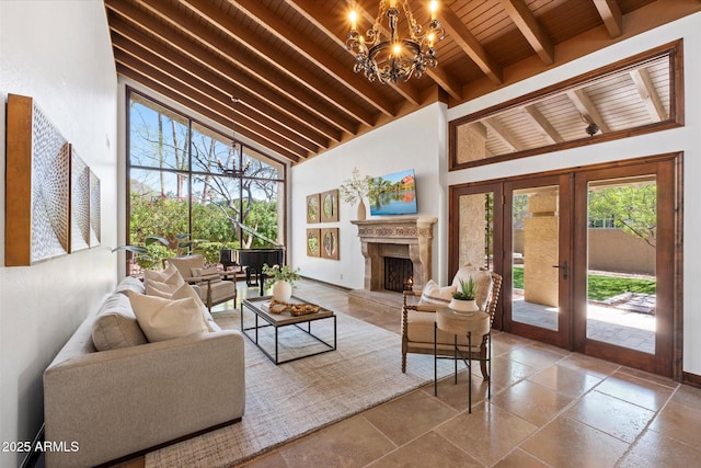 living area featuring beamed ceiling, french doors, wooden ceiling, and an inviting chandelier